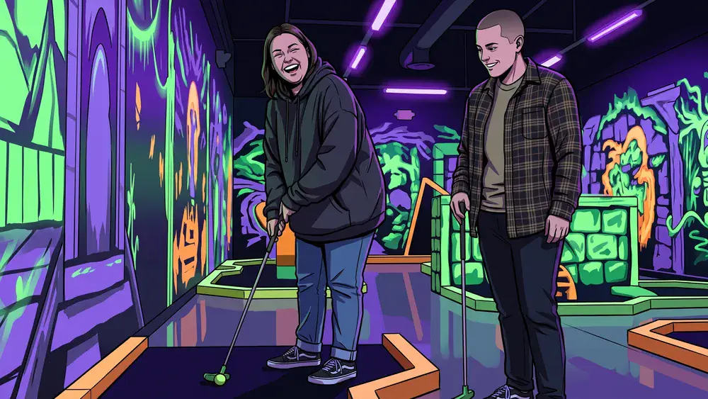 GolfZone Schwarzlicht Minigolf in Bielefeld – Zwei Personen spielen im Neonlicht