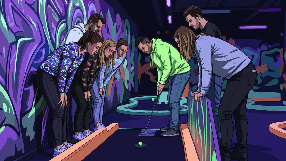 Schwarzlicht-Minigolf in Bielefeld – JGA-Gruppe spielt eine Bahn unter Neonlicht