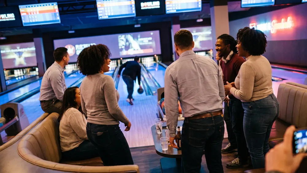 Bowling in Kiel – Team jubelt an einer modernen Bowlingbahn bei Champs Bowling