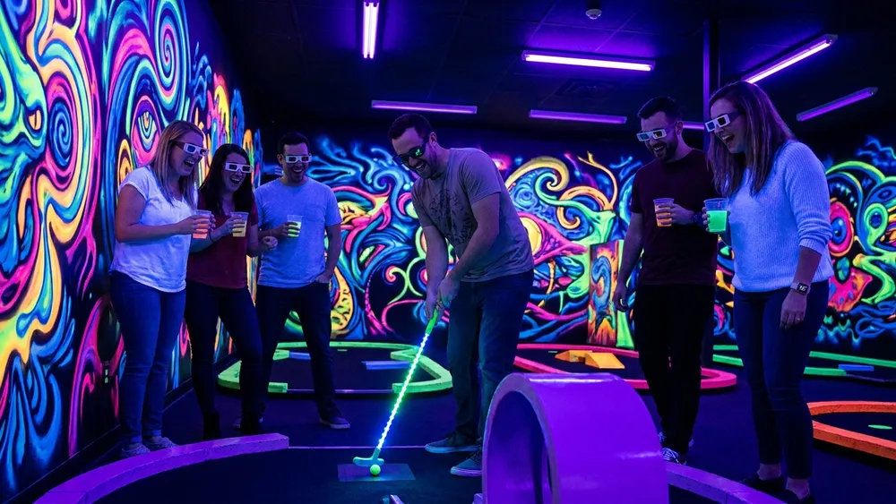 Schwarzlicht Minigolf in Stuttgart - Erwachsene spielen mit 3D-Brillen Minigolf in leuchtender Neonwelt
